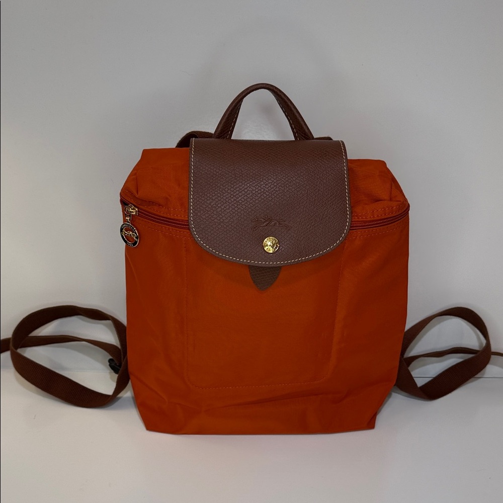 Longchamp Le Pliage Backpack in Pumpkin with Brown Leather. Packable. New.